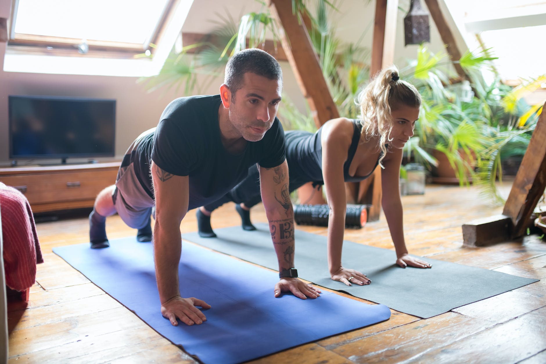 man and woman doing push ups together